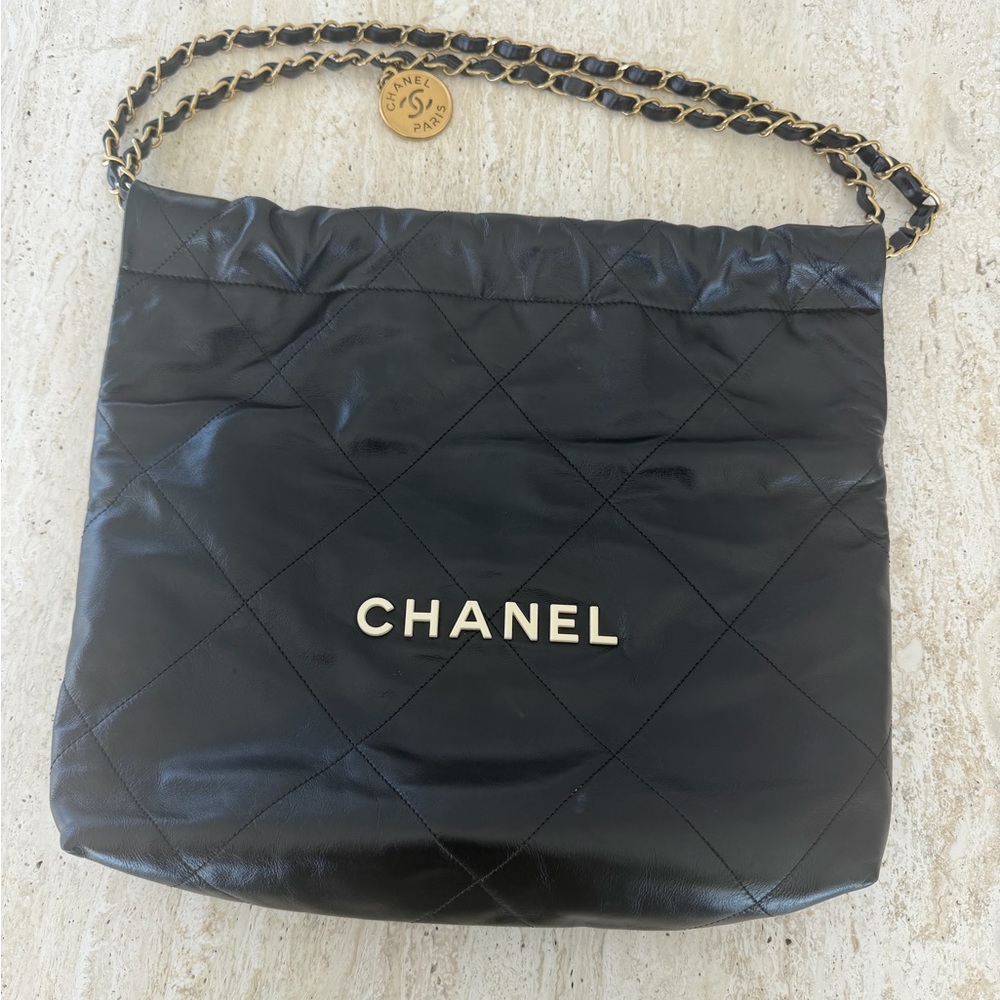 CHANEL Black Quilted Leather 22 Bag with Gold Chain